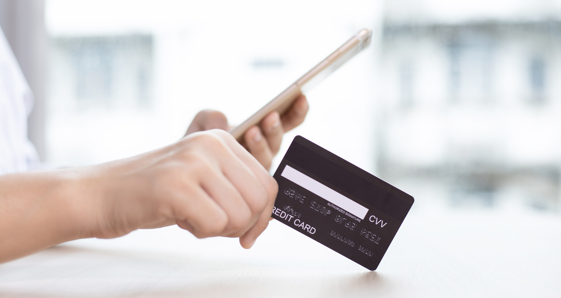 Person Using Credit Card To Purchase Online Orders